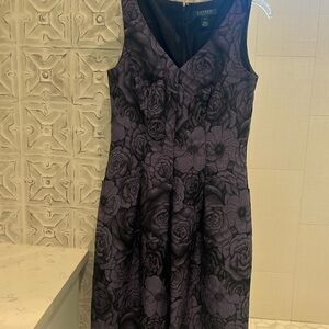 People and black floral v-neck dress